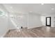 Bright open space features light hardwood floors, white walls, many windows, and a modern black door at 2302 S Pennsylvania St, Indianapolis, IN 46225