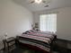Cozy bedroom with natural light from the window, with a patterned comforter and side tables at 240 Legends Creek Pl # Apt 310, Indianapolis, IN 46229