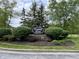 Welcome to Legends Creek: A beautiful community entrance framed by lush landscaping and mature trees at 240 Legends Creek Pl # Apt 310, Indianapolis, IN 46229