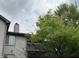 Exterior angle of a condo complex shows balconies, siding and well-maintained landscaping and mature trees at 240 Legends Creek Pl # Apt 310, Indianapolis, IN 46229