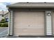 A one-car garage door with unit number 13 in neutral tones at 240 Legends Creek Pl # Apt 310, Indianapolis, IN 46229