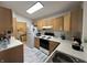 Cozy kitchen with wooden cabinets, white appliances, countertops, and modern flooring at 240 Legends Creek Pl # Apt 310, Indianapolis, IN 46229