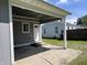 A covered back porch shows easy outdoor living with shaded space, a back door and manicured lawn at 2417 Crystal St, Anderson, IN 46012