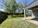 Expansive backyard featuring a well-manicured lawn, mature trees, and a private patio area at 2417 Crystal St, Anderson, IN 46012