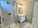 The updated bathroom features a glass-enclosed shower and vanity with modern lighting at 2417 Crystal St, Anderson, IN 46012
