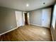 The bedroom has wood-look flooring and white doors, offering a bright, neutral palette at 2417 Crystal St, Anderson, IN 46012
