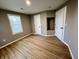 Neutral bedroom features wood-look floors, a window, and convenient closet and alcove at 2417 Crystal St, Anderson, IN 46012