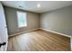 A bright bedroom features wood-look flooring and a window with natural light at 2417 Crystal St, Anderson, IN 46012
