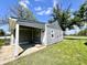Cozy home features gray siding, white trim, and covered parking and front entrance at 2417 Crystal St, Anderson, IN 46012