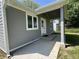 Exterior of a home with a covered porch and updated gray siding at 2417 Crystal St, Anderson, IN 46012