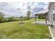 Large grassy backyard with a fire pit and pergola-covered patio, perfect for outdoor entertaining and relaxation at 2780 Cormorant Dr, Greenwood, IN 46143
