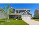 Charming two-story home featuring a manicured lawn, attached two-car garage, and beautiful curb appeal at 2780 Cormorant Dr, Greenwood, IN 46143