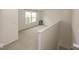 Cozy loft space with neutral carpet, staircase, and a bright window at 2780 Cormorant Dr, Greenwood, IN 46143