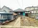 Backyard featuring a house with a turquoise door and a dumpster at 309 N Forest Ave, Indianapolis, IN 46201