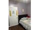Bedroom featuring a bed with a patchwork quilt and decor adorning the door and walls at 309 N Forest Ave, Indianapolis, IN 46201