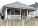 Charming home featuring a stone facade, inviting front porch with white railings and a vibrant red front door at 309 N Forest Ave, Indianapolis, IN 46201