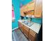 Functional kitchen with wooden cabinetry, white countertops, offering a practical space for meal preparation at 309 N Forest Ave, Indianapolis, IN 46201