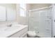 Bright bathroom featuring a white vanity, toilet, and shower with glass doors at 3256 Fawn Cir, Brownsburg, IN 46112
