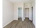 A bedroom with wood floors and neutral walls is illuminated by natural light at 3256 Fawn Cir, Brownsburg, IN 46112