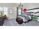 This bedroom features a unique striped accent wall, modern lighting, and comfortable seating at 3256 Fawn Cir, Brownsburg, IN 46112