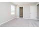 Well-lit bedroom with plush carpet, a window, and a door leading to a closet at 3256 Fawn Cir, Brownsburg, IN 46112