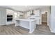 Bright, open kitchen with a large island, stainless steel appliances, and white cabinets at 3256 Fawn Cir, Brownsburg, IN 46112