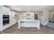 Modern kitchen features white cabinets, an island with seating, and stainless steel appliances at 3256 Fawn Cir, Brownsburg, IN 46112