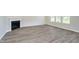 Spacious living room with hardwood floors, fireplace, and natural light from large windows at 3256 Fawn Cir, Brownsburg, IN 46112