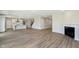 Open-concept layout connecting the living room with a fireplace to the kitchen and staircase at 3256 Fawn Cir, Brownsburg, IN 46112