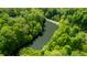 Scenic aerial view featuring a serene pond surrounded by lush, mature trees in a peaceful setting at 3273 Bailey Dr, Morgantown, IN 46160