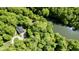 Beautiful aerial showcasing a charming home nestled in dense woods, with a nearby stream at 3273 Bailey Dr, Morgantown, IN 46160