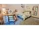 Bright bedroom features a charming vanity area and a cozy bed with decorative pillows and blanket at 3273 Bailey Dr, Morgantown, IN 46160