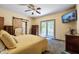Cozy bedroom with neutral tones, ceiling fan, and access to a private balcony at 3273 Bailey Dr, Morgantown, IN 46160