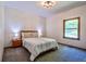 Comfortable bedroom features soft lighting from bedside lamps and a peaceful window view at 3273 Bailey Dr, Morgantown, IN 46160