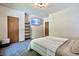 Clean, modern bedroom with two doors, flat screen, shelving and comfortable carpet at 3273 Bailey Dr, Morgantown, IN 46160