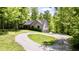 Charming home with gravel drive, manicured lawn, and a covered porch surrounded by lush trees at 3273 Bailey Dr, Morgantown, IN 46160