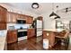 Updated kitchen featuring wood cabinets, island with bar seating, and modern appliances at 3273 Bailey Dr, Morgantown, IN 46160