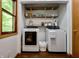 Functional laundry room with modern washer and dryer units and ample shelving for storage at 3273 Bailey Dr, Morgantown, IN 46160