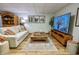 Cozy finished basement with comfortable seating, decorative accents, and a large television screen at 3273 Bailey Dr, Morgantown, IN 46160