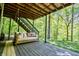 Relaxing outdoor patio with a swing bed overlooking lush greenery and woodland scenery at 3273 Bailey Dr, Morgantown, IN 46160