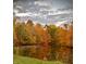Scenic view of a pond surrounded by vibrant autumn foliage and a cloudy sky at 3273 Bailey Dr, Morgantown, IN 46160