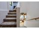 Carpeted stairway, leading down to additional finished space and a small landing to a utility area at 3273 Bailey Dr, Morgantown, IN 46160