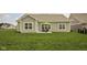 Spacious backyard with a green lawn and patio area, great for outdoor activities at 3622 S Setting Sun Ln, New Palestine, IN 46163