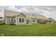 Manicured backyard with a patio and green grass, perfect for outdoor entertaining at 3622 S Setting Sun Ln, New Palestine, IN 46163