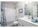 Bright bathroom featuring a shower-tub combination, a white vanity, and tasteful blue decor for a clean aesthetic at 3622 S Setting Sun Ln, New Palestine, IN 46163