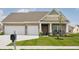 Charming craftsman home featuring a three-car garage and a beautifully landscaped front yard at 3622 S Setting Sun Ln, New Palestine, IN 46163