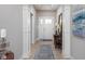 Inviting foyer featuring hardwood floors, elegant lighting, and a stylish console table with decorative accents at 3622 S Setting Sun Ln, New Palestine, IN 46163