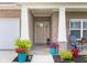 Charming covered front porch area featuring decorative planters and a seating area for relaxation at 3622 S Setting Sun Ln, New Palestine, IN 46163