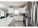 A modern kitchen with stainless steel appliances, white cabinets, and quartz countertops at 3622 S Setting Sun Ln, New Palestine, IN 46163