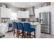 A stylish kitchen with stainless steel appliances, white cabinets, and a breakfast bar with seating at 3622 S Setting Sun Ln, New Palestine, IN 46163